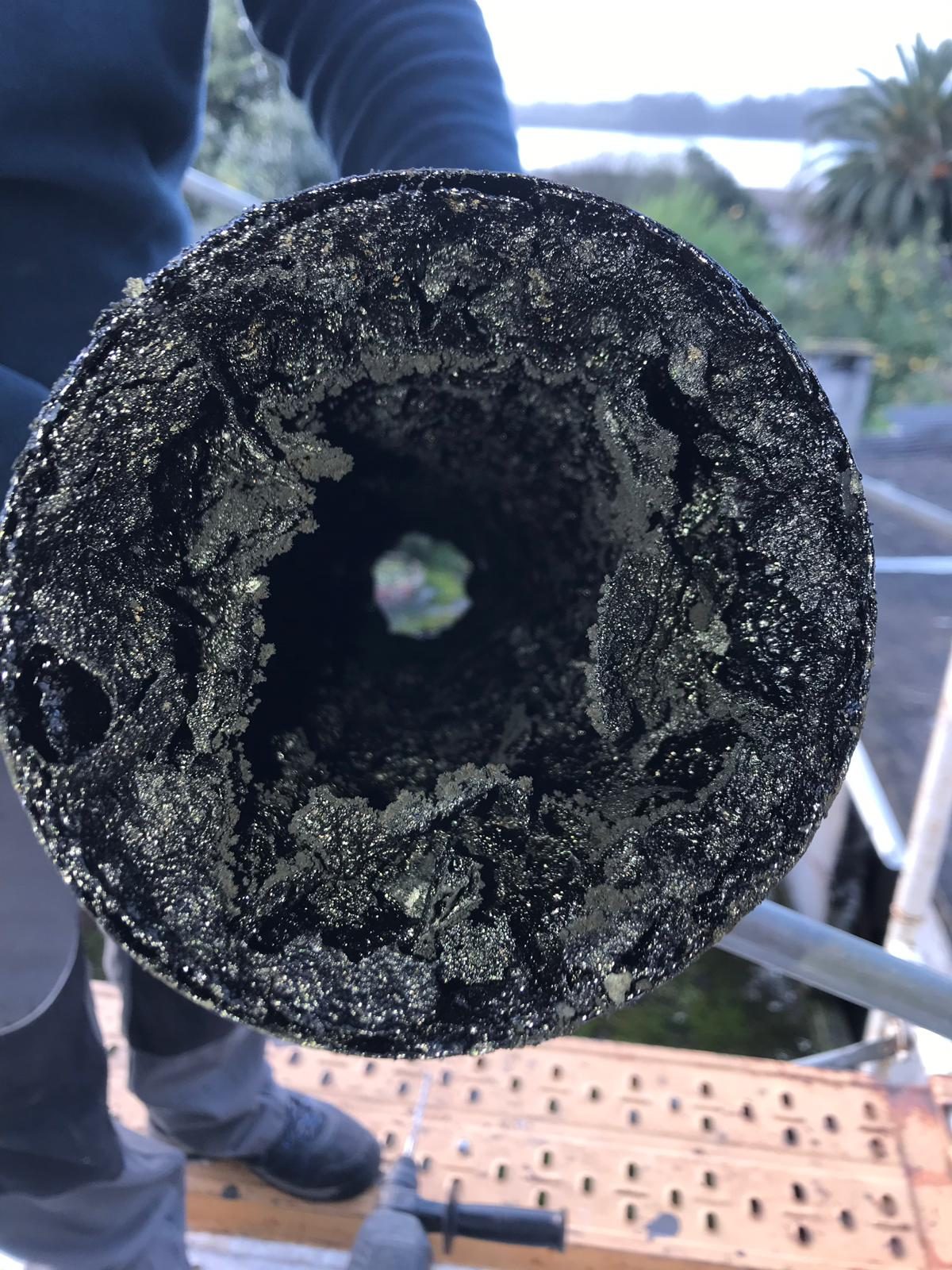 Conducto de humos atascado de creosota antes del deshollinado